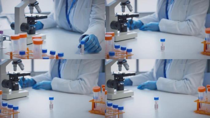 实验室工作人员使用显微镜进行研究，将血液样品标记为ab型
