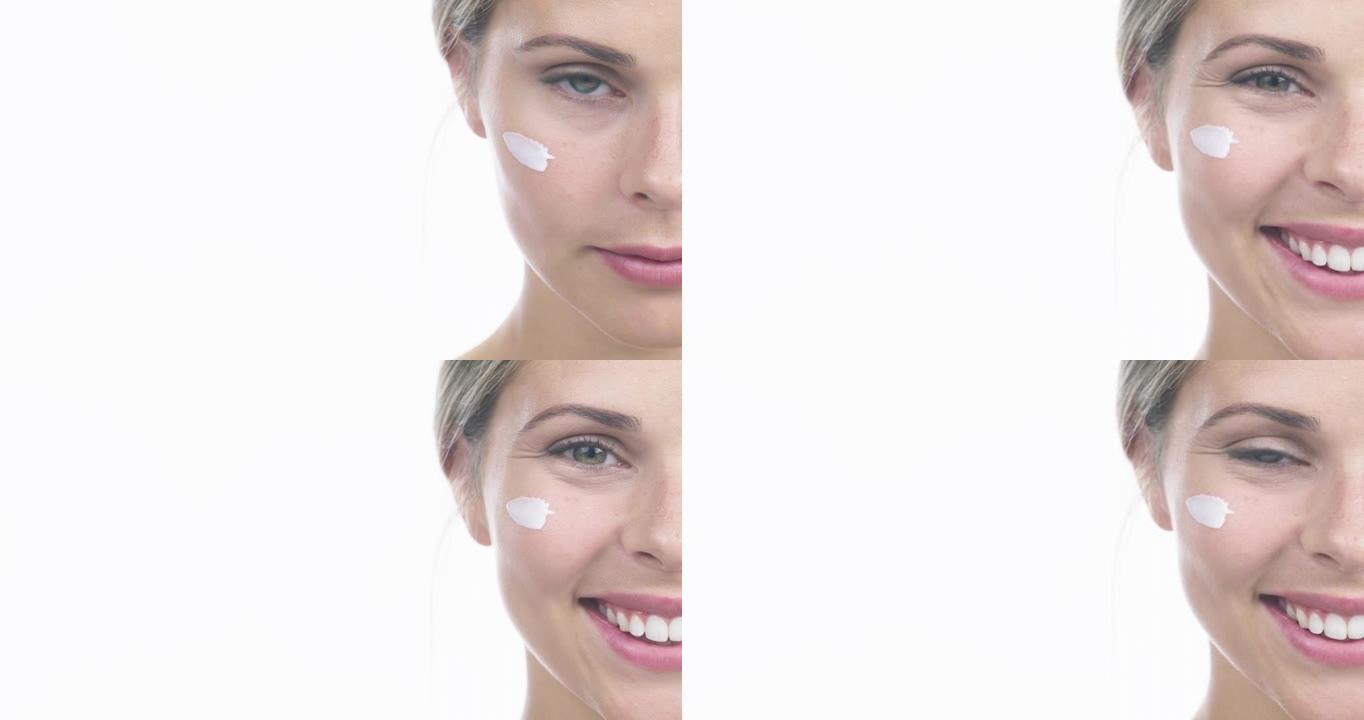 4k视频片段，一位迷人的年轻女子在白色工作室背景下使用保湿霜