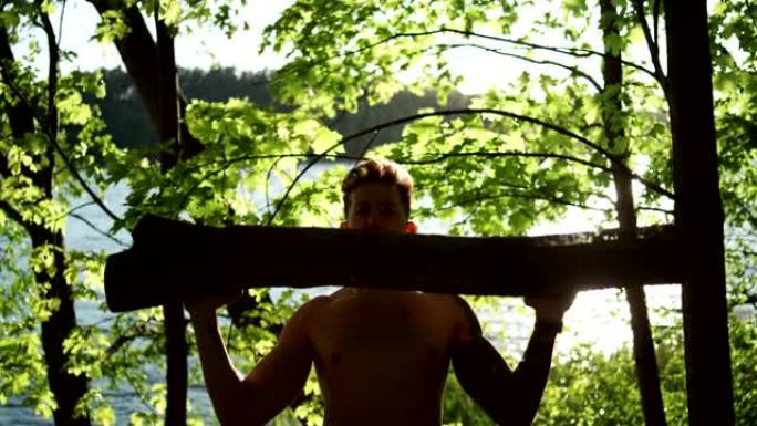 森林交叉训练。男子举起大原木