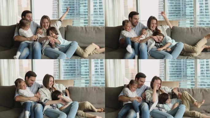 Cheerful happy young parents tickling sweet little