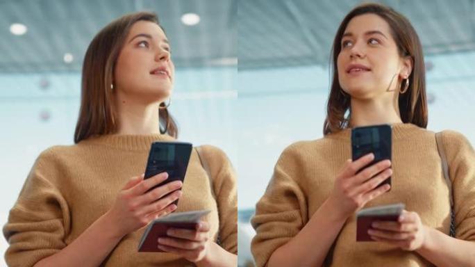 垂直屏幕。机场航站楼: 快乐旅行的白人妇女在登机口等待登机，使用移动智能手机，在互联网上检查旅行目的