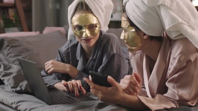 戴着床单面具的女孩在床上使用笔记本电脑