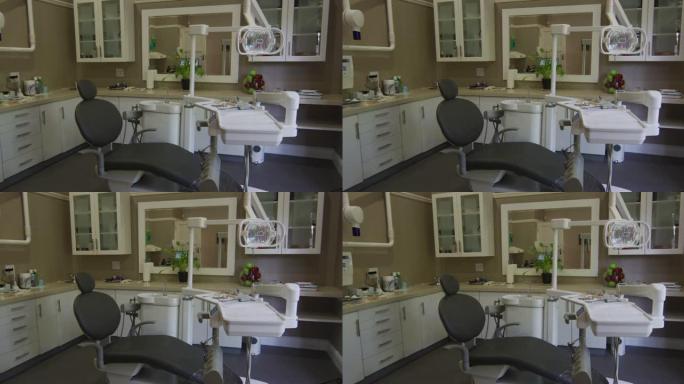 牙科诊所的空内部，配有黑色牙科椅和工具