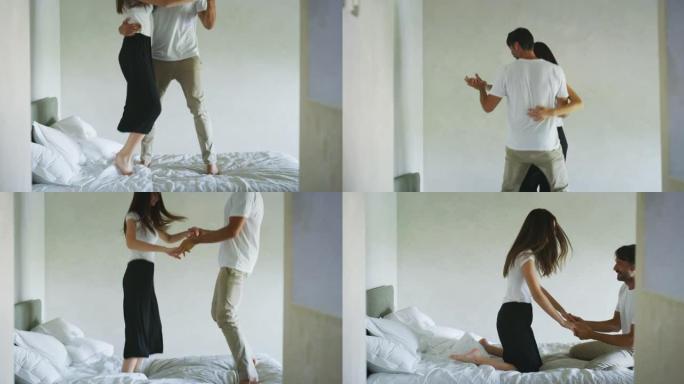 恋爱中的年轻夫妇在早上在卧室的床上听音乐时玩耍和跳舞。