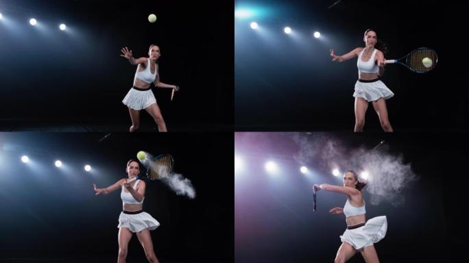 一名黑色背景的运动女网球运动员在聚光灯下击球的美学镜头。电影般的超级慢动作捕捉到了一个具有烟熏效果的