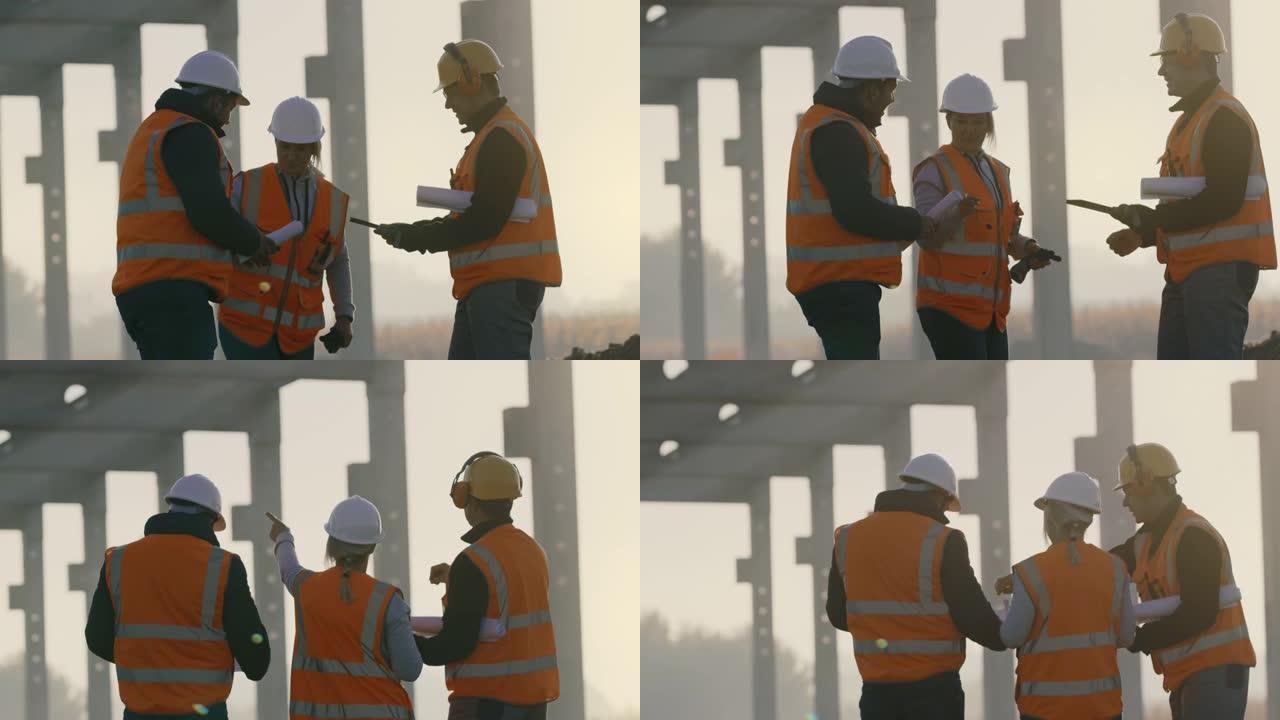 SLO MO三名建筑工人在施工现场检查钢结构建筑