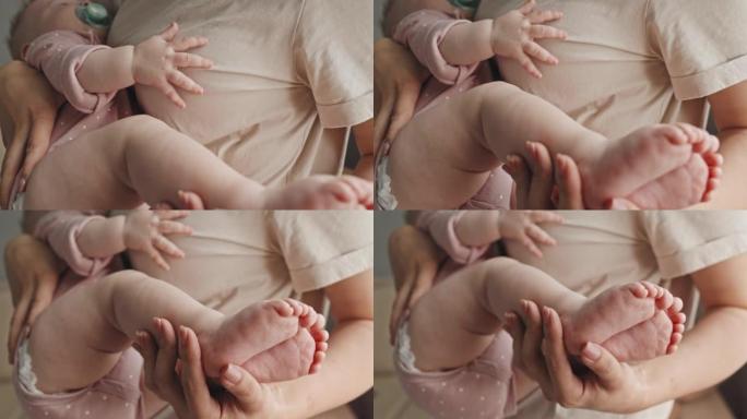 妈妈抱着熟睡的婴儿的脚