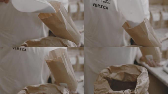 女工将面粉从麻袋倒入纸袋的特写