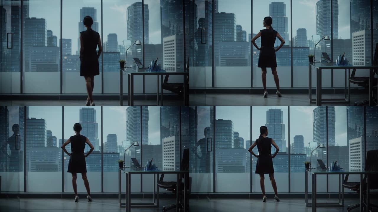 成功的女商人穿着时髦的衣服，看着窗外的大城市在市中心。自信的从事金融项目的女首席执行官。工作计划营销