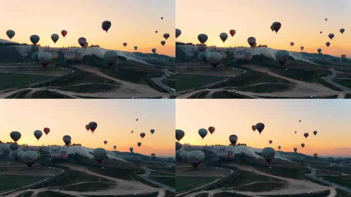 热气球在棉花堡山谷上空升起，对抗山脉和喜怒无常的天空。空中无人机视频