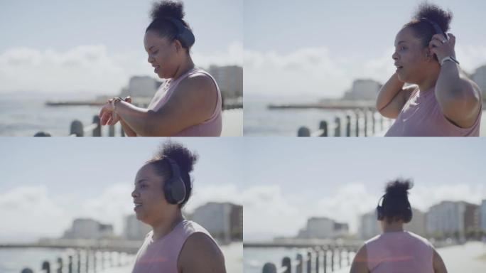 超大号的女人在她的智能手表上追踪她的目标，并在城市跑步。较大的活跃的非洲裔美国妇女适应常规的户外锻炼