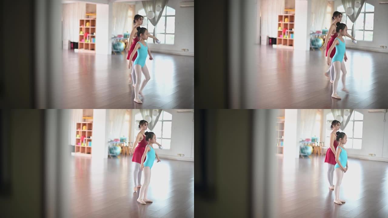 亚洲中国少女芭蕾舞演员在工作室训练她的年轻女学生