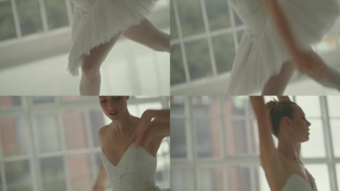 美丽，优雅，优雅的芭蕾舞演员在靠近窗户的空荡荡的舞蹈工作室里独自跳舞。年轻的古典女芭蕾舞演员在玻璃墙
