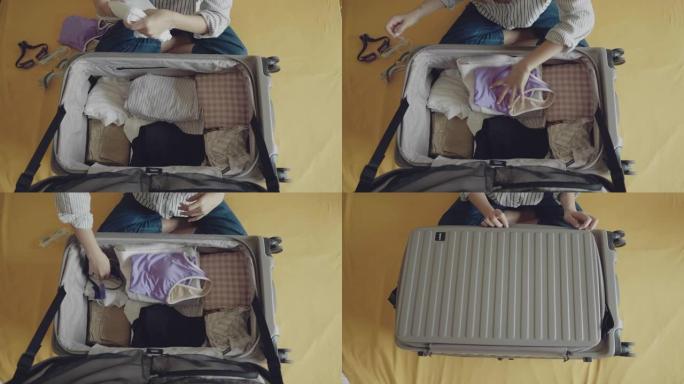 女性在手提箱里打包衣服