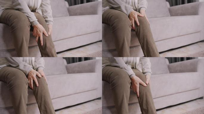 4k分辨率亚洲高级女性用手按摩腿部疼痛。保健概念。特写镜头。