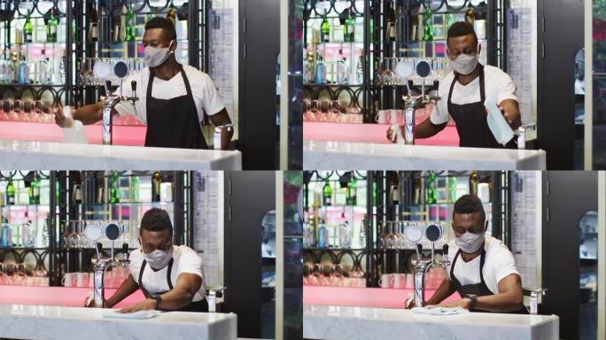 非裔美国男性咖啡师戴口罩消毒棒表面