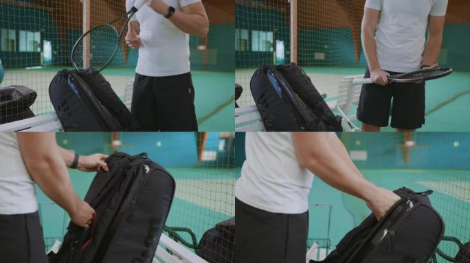 年轻男教练在室内网球场检查网球拍网的质量