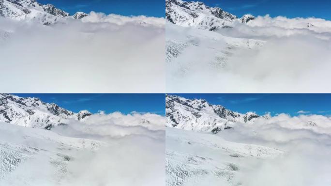 雪山矗立在云海上穿过云雾雪景白皑皑的一片