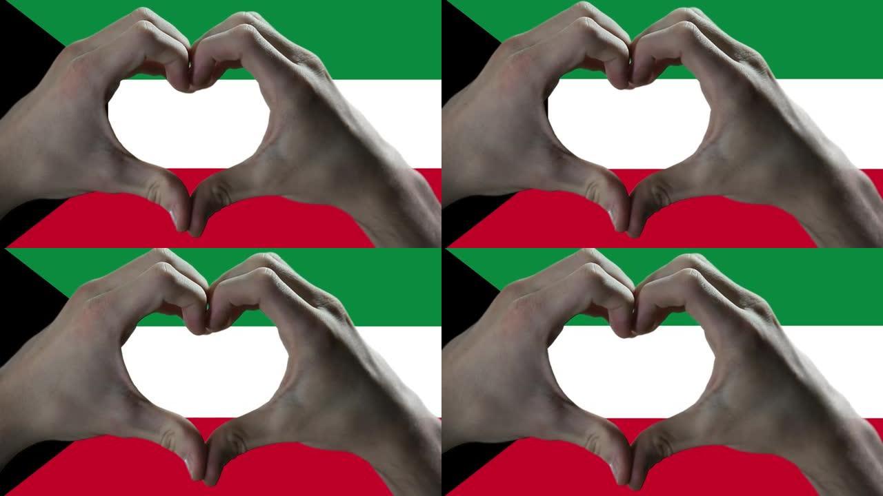 双手在科威特国旗上显示心脏标志。