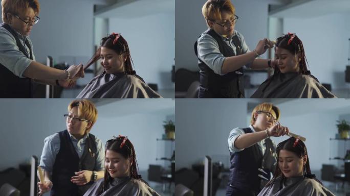 亚洲华人发型师在美发沙龙为她的顾客理发