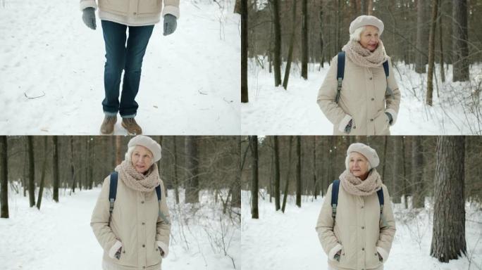 冬天在森林里散步的老妇人享受健康活动的俯仰肖像