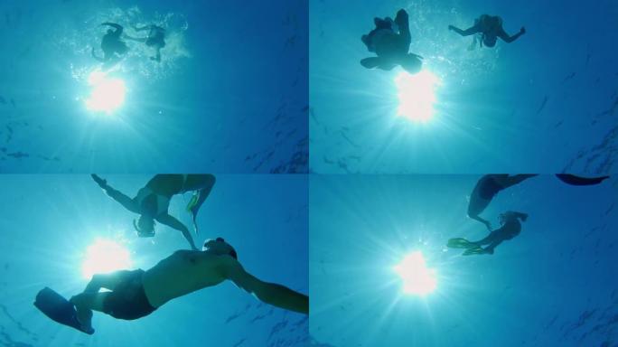 女士夫妇在克罗地亚阳光明媚的蓝色亚得里亚海的水下浮潜