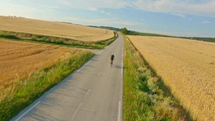 空中骑自行车的人在穿越乡村的道路上骑自行车