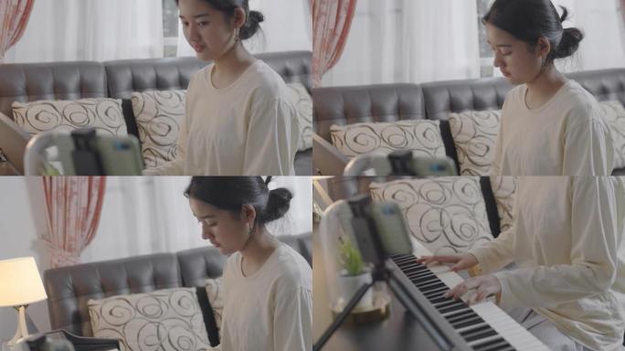 特写亚洲少女用音乐弹奏钢琴电话会议。通过互联网上的视频通话播放。可爱的女孩玩电钢琴玩得开心。音乐家青