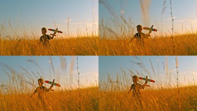 时间扭曲男孩在金色的草地上玩飞机玩具
