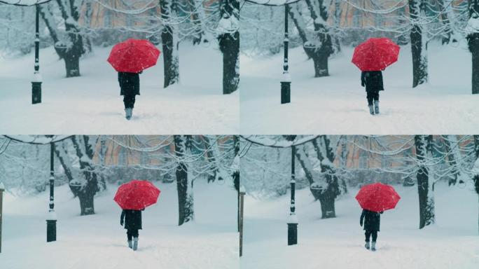 慢动作: 举着红色雨伞的女人沿着空旷的白雪皑皑的大道行走。