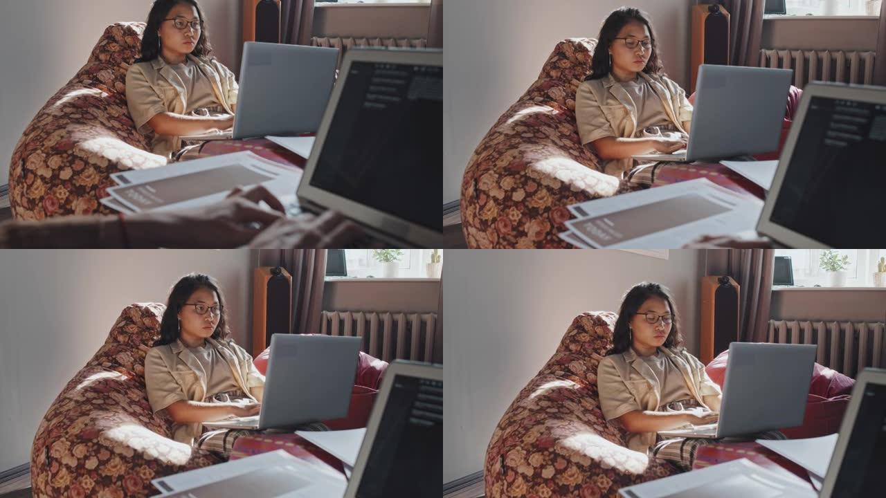 在办公空间从事笔记本电脑工作的亚洲女性