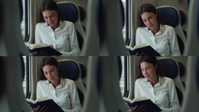 女商人在看书和乘火车旅行时放松和微笑的肖像照片。女员工早上在去办公室的路上享受小说文学