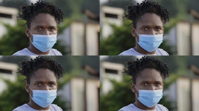 Poverty.Inequality。在贫民窟周围，一名非洲黑人男子戴着保护面罩看着摄像机的特写。
