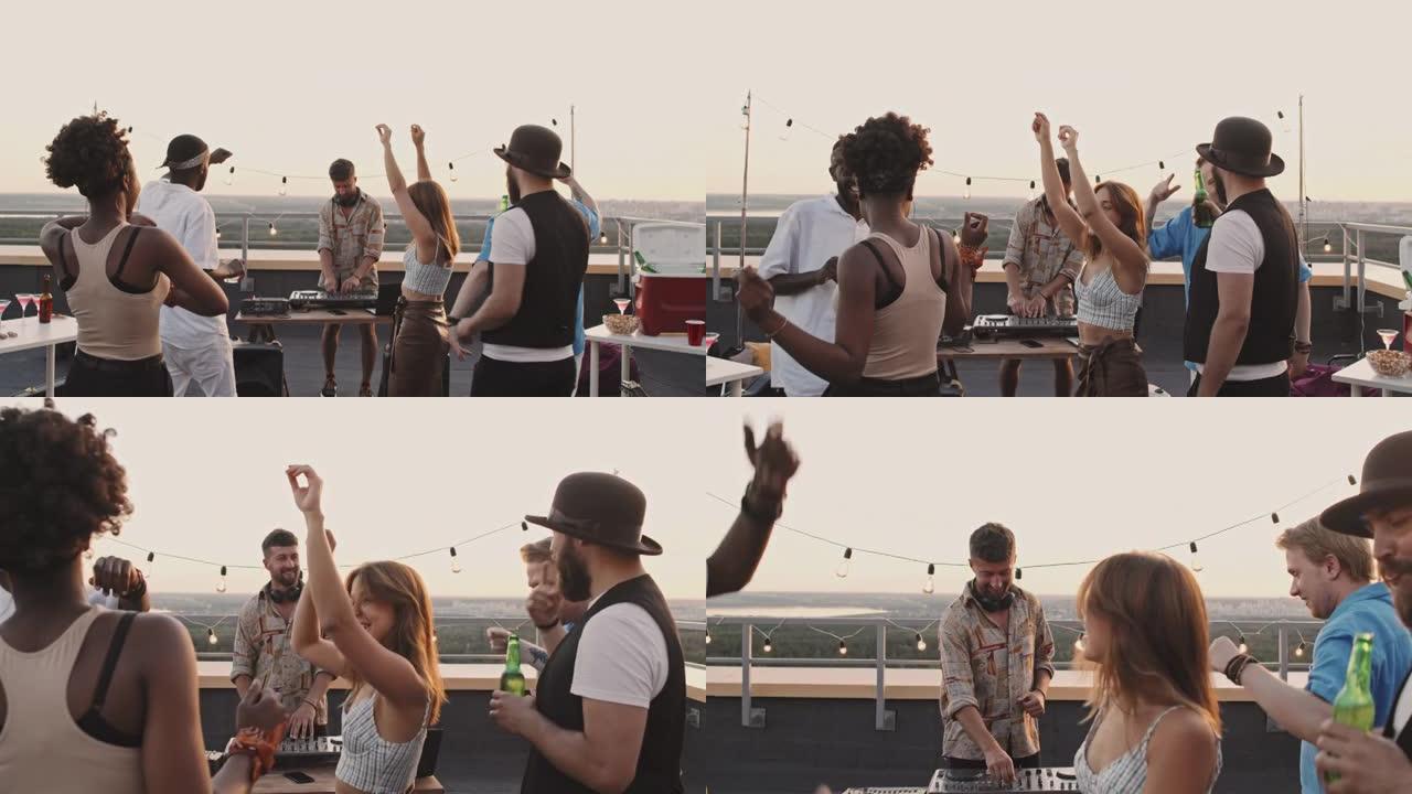 男子dj和人们在屋顶露台上跳舞