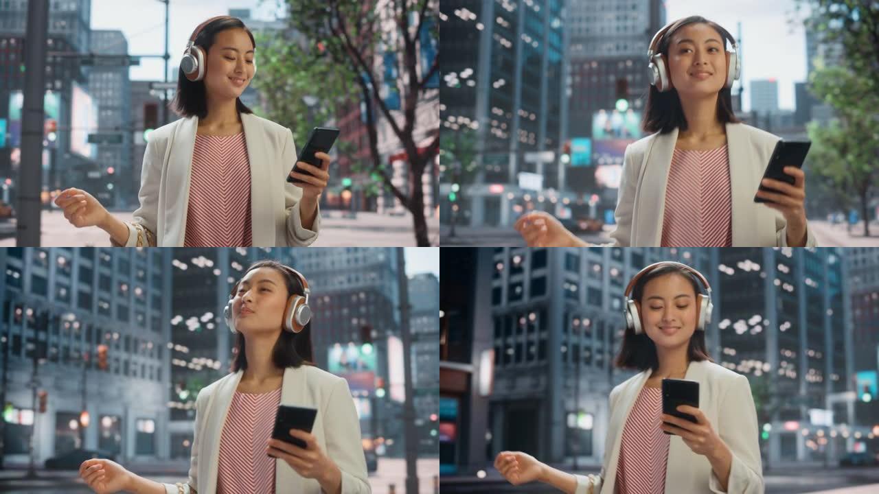 一位美丽的日本女性的肖像随便走在街上，用智能手机的耳机听音乐。她在大城市中使用电话，向人们发送在线消