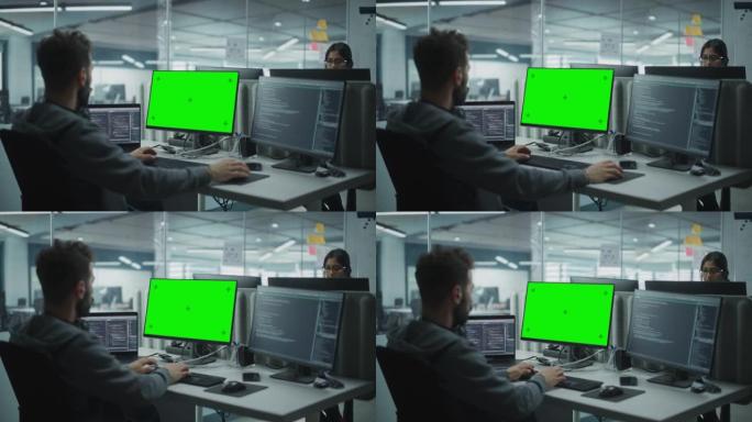 多民族办公室: 使用绿屏色度键显示在计算机上工作的IT程序员。男软件工程师开发应用程序，程序，视频游