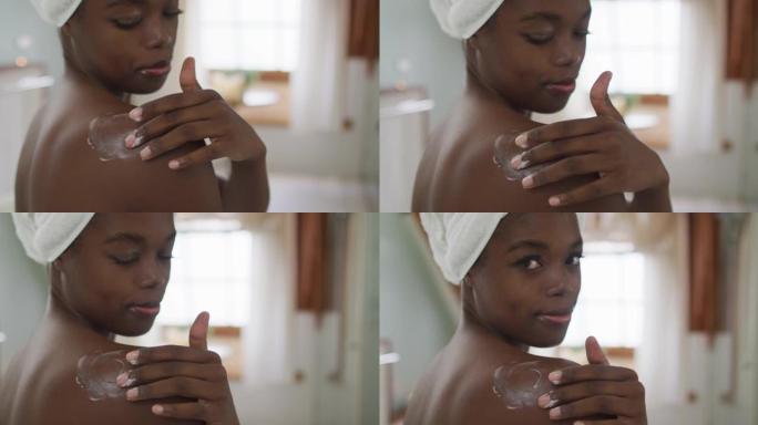 非裔美国迷人女性在浴室涂抹润唇膏的肖像