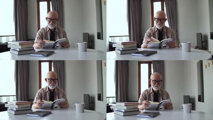 老人在家读书退休，退休生活。年长的男性阅读，放松和坐在沙发上，退休老人和眼镜的视力