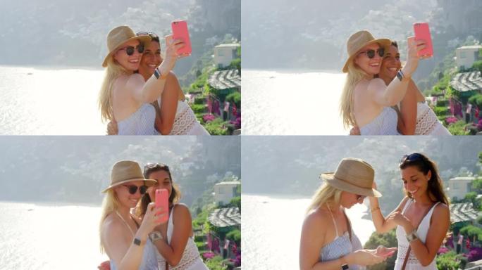 两个快乐的朋友在意大利度假时在美丽的景色前用手机自拍