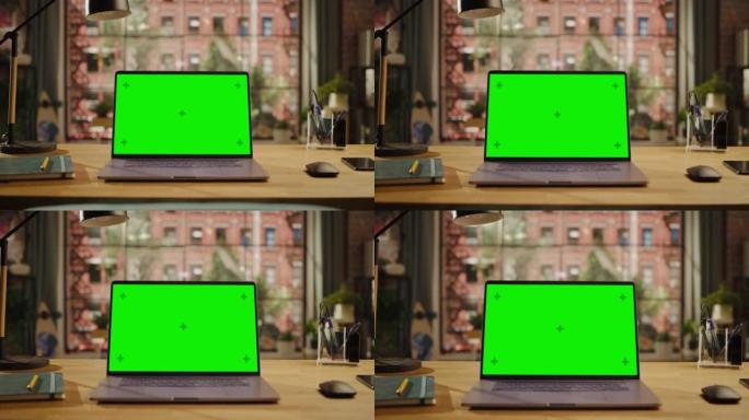 笔记本电脑显示屏，带有模拟绿屏，站在客厅的木制桌子上，笔记本电脑和智能手机。家里或创意阁楼办公室的色