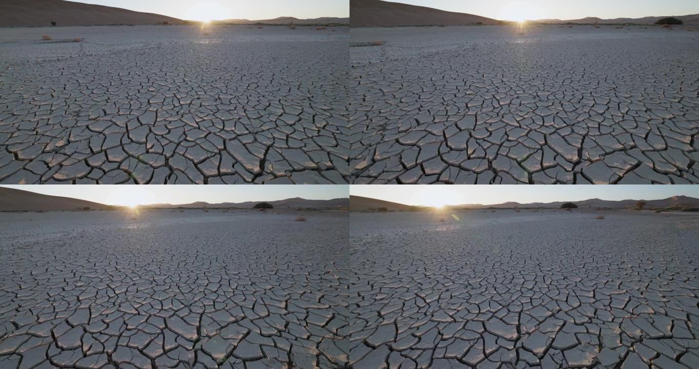 气候变化。由于气候变化和全球变暖造成的干旱，干旱大坝的图案化开裂的泥浆表面的平移视图