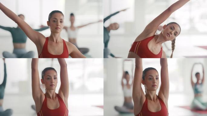 健身的年轻女子在健身工作室的健身课上练习瑜伽。集中活跃的女性伸展和弯曲，以在小组训练期间执行一系列姿