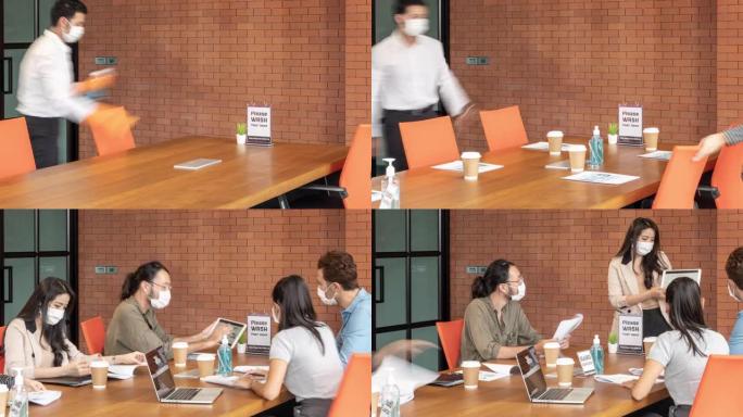 4K UHD延时新的正常会议和头脑风暴在会议室用洗手液，所有商务人员都戴上防护口罩，以防止在全球大流