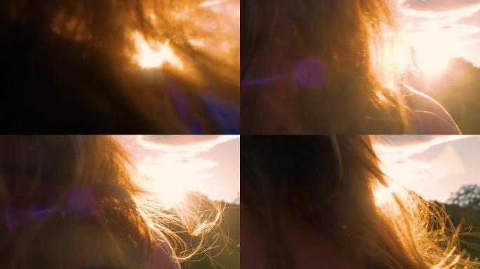 特写镜头耀斑: 温和的夏日风吹过女人的波浪长发