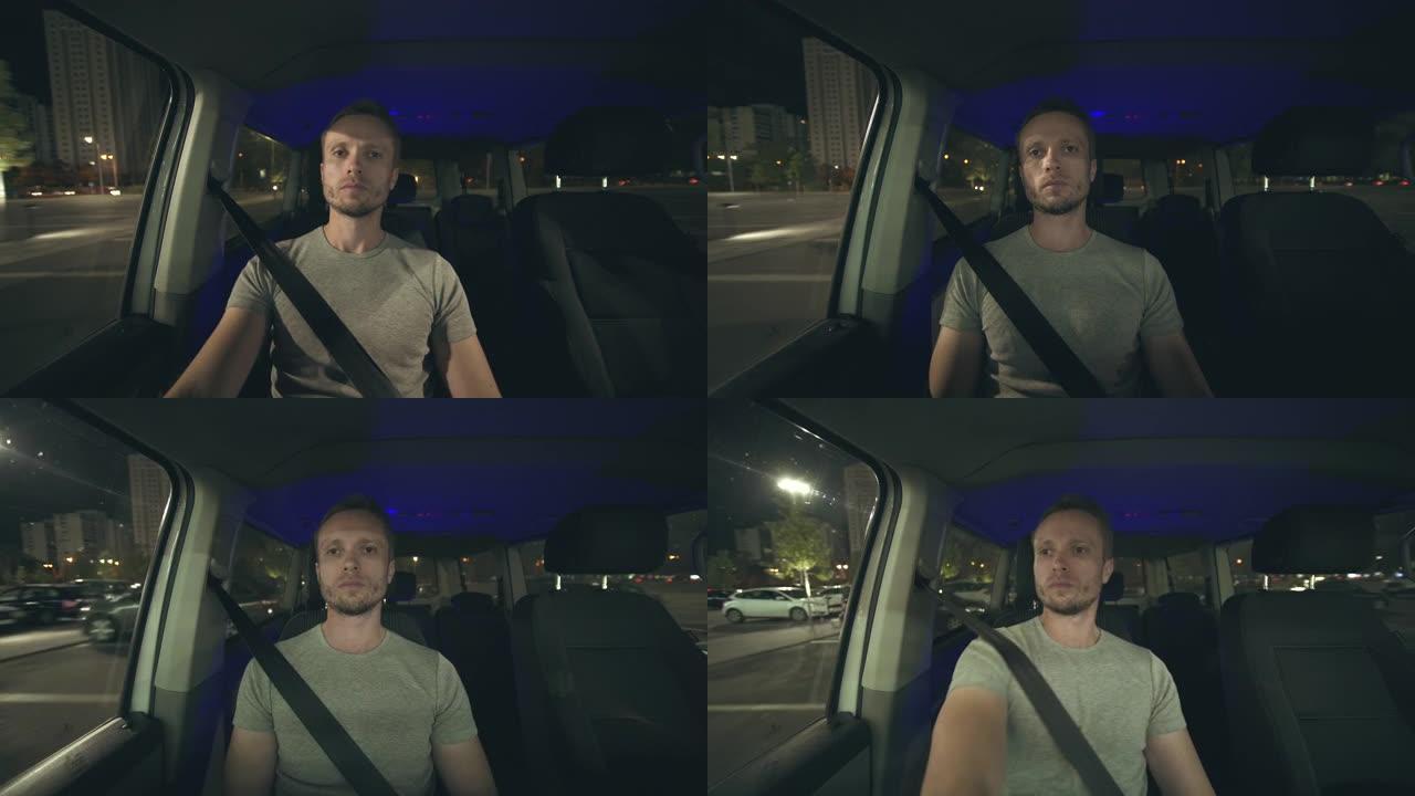 男人晚上开车。车辆内部视图