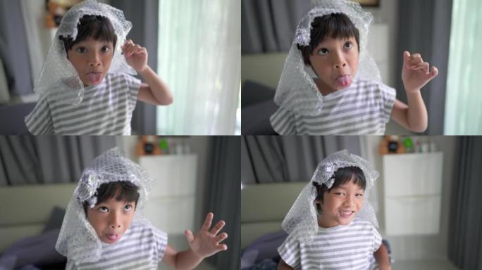 亚洲小男孩在家玩泡泡帽