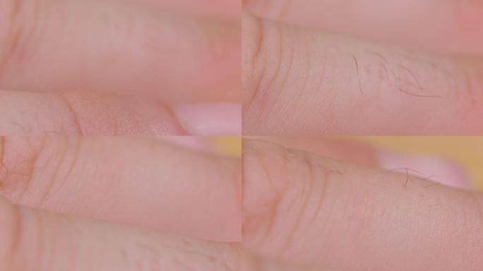 宏观，dop: 一个无法辨认的男人毛茸茸的指关节的详细特写镜头。