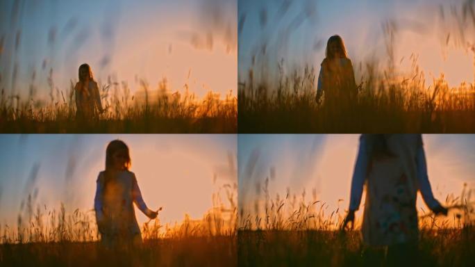 日落时，带着花束的SLO MO小女孩在高草丛中行走