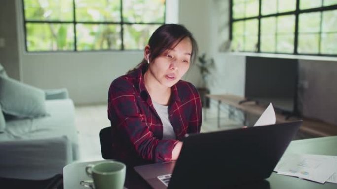 亚洲女商人在家中在笔记本电脑上进行视频会议