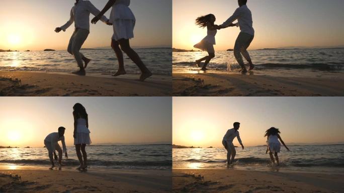 一对年轻无忧无虑的幸福夫妇的真实照片是玩得开心，日落时在海边海滩一起享受他们的暑假浪漫假期。